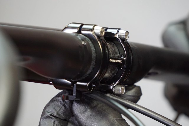 Cane Creek manufacturer HCR faceplate close-up in black with cable guide; stem length is not visible. Catalog variant: 120 mm Black (BAJ0137).